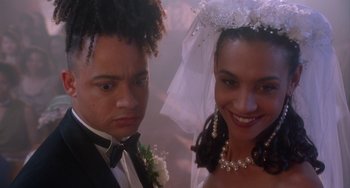 Movie still from “House Party 3” (1994), directed by Eric Meza – A man and a woman posing for a wedding picture; Close Up shot, High angle