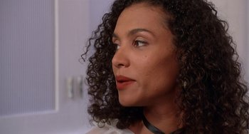 Movie still from “House Party 3” (1994), directed by Eric Meza – A person with curly black hair; Close Up shot, Over the shoulder angle