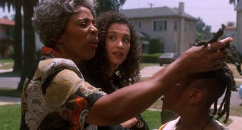 Movie still from “House Party 3” (1994), directed by Eric Meza – A woman and a young girl looking at something on a phone; Close Up shot, Over the shoulder angle