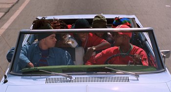 Movie still from “House Party 3” (1994), directed by Eric Meza – A group of people sitting in the back of a car; Medium shot, High angle