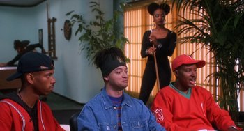 Movie still from “House Party 3” (1994), directed by Eric Meza – A group of people sitting in a living room; Medium shot, High angle