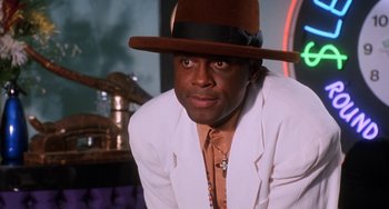 Movie still from “House Party 3” (1994), directed by Eric Meza – A man in a white jacket and a brown hat; Close Up shot, Low angle