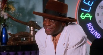 Movie still from “House Party 3” (1994), directed by Eric Meza – A man wearing a brown hat and a white jacket; Close Up shot, Low angle