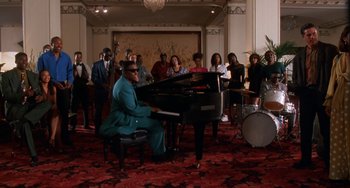 Movie still from “House Party 3” (1994), directed by Eric Meza – A man sitting at a piano in front of a group of people; Extreme Wide shot, Low angle