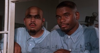 Movie still from “House Party 3” (1994), directed by Eric Meza – A couple of men sitting next to each other; Close Up shot, Low angle