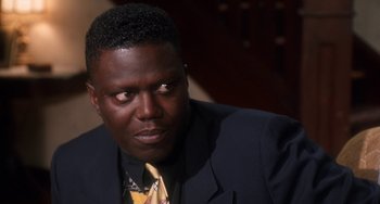 Movie still from “House Party 3” (1994), directed by Eric Meza – A person wearing a suit and tie; Close Up shot, High angle