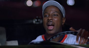 Movie still from “House Party 3” (1994), directed by Eric Meza – A man with a tennis racquet in his hand; Close Up shot, Low angle