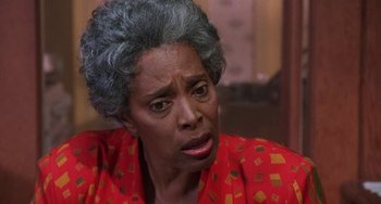 Movie still from “House Party 3” (1994), directed by Eric Meza – An older black woman in a red and yellow shirt; Close Up shot, Over the shoulder angle