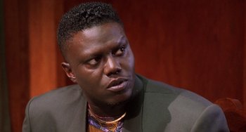 Movie still from “House Party 3” (1994), directed by Eric Meza – A person wearing a suit and tie; Close Up shot, High angle