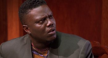 Movie still from “House Party 3” (1994), directed by Eric Meza – A person wearing a suit; Close Up shot, Low angle