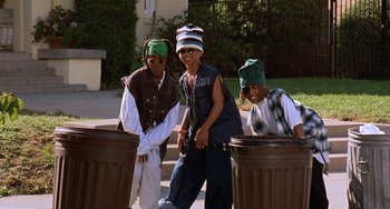 Movie still from “House Party 3” (1994), directed by Eric Meza – A group of young men standing next to trash cans; Medium shot, Low angle