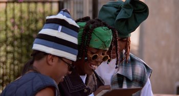 Movie still from “House Party 3” (1994), directed by Eric Meza – A group of young people looking at something on a tablet; Close Up shot, Low angle