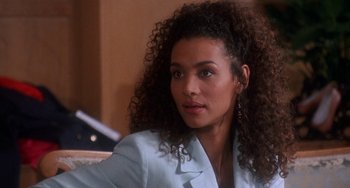 Movie still from “House Party 3” (1994), directed by Eric Meza – A woman sitting down looking at the camera; Close Up shot, Over the shoulder angle
