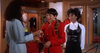 Movie still from “House Party 3” (1994), directed by Eric Meza – A group of women standing next to each other in a room; Medium shot, Over the shoulder angle