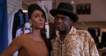 Movie still from “House Party 3” (1994), directed by Eric Meza – A man and a woman pose for a picture; Close Up shot, Low angle