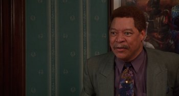 Movie still from “House Party 3” (1994), directed by Eric Meza – A man in a suit and tie smiling for the camera; Close Up shot, High angle