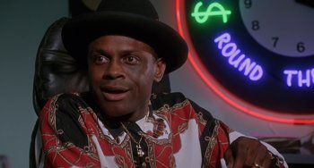 Movie still from “House Party 3” (1994), directed by Eric Meza – A man wearing a black hat and a red and white shirt; Close Up shot, Over the shoulder angle