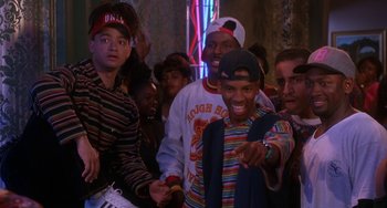 Movie still from “House Party 3” (1994), directed by Eric Meza – A group of young men standing next to each other in a room; Medium shot, High angle