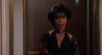 Movie still from “House Party 3” (1994), directed by Eric Meza – A woman in a black dress and a black choker; Close Up shot, Over the shoulder angle
