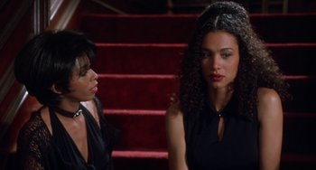 Movie still from “House Party 3” (1994), directed by Eric Meza – Two women are sitting on the steps of a red staircase; Close Up shot, High angle