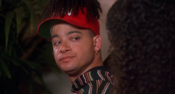 Movie still from “House Party 3” (1994), directed by Eric Meza – A young man with a red hat and a red cap; Close Up shot, Low angle