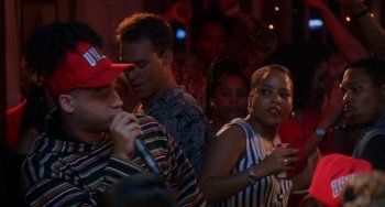 Movie still from “House Party 3” (1994), directed by Eric Meza – A group of people standing around each other at a party; Medium shot, Over the shoulder angle
