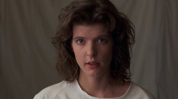 Movie still from “House of Games” (1987), directed by David Mamet – A person wearing a white shirt; Close Up shot, Low angle