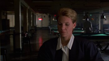 Movie still from “House of Games” (1987), directed by David Mamet – A woman with blonde hair wearing a black jacket and a white shirt; Close Up shot, Over the shoulder angle