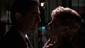 Movie still from “House of Games” (1987), directed by David Mamet – A man and a woman face to face in the dark; Close Up shot, Low angle