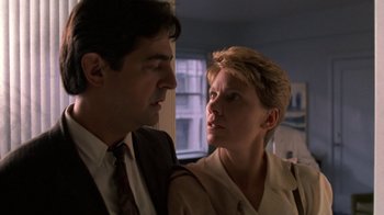 Movie still from “House of Games” (1987), directed by David Mamet – A man and a woman standing next to each other; Close Up shot, Low angle