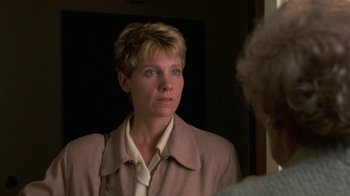 Movie still from “House of Games” (1987), directed by David Mamet – A woman looking at her reflection in a mirror; Close Up shot, Over the shoulder angle