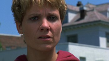 Movie still from “House of Games” (1987), directed by David Mamet – A person with short blonde hair; Close Up shot, Low angle