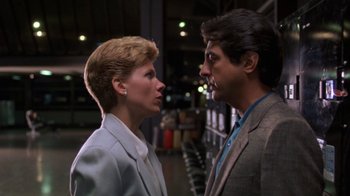 Movie still from “House of Games” (1987), directed by David Mamet – A man and a woman standing next to each other; Close Up shot, Low angle