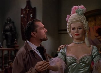 Movie still from “House of Wax” (1953), directed by André De Toth – A man standing next to a woman wearing a hat; Medium shot, Low angle