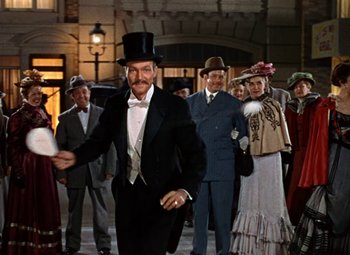 Movie still from “House of Wax” (1953), directed by André De Toth – A man wearing a top hat and a tie; Wide shot, Low angle
