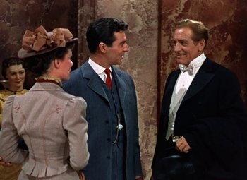 Movie still from “House of Wax” (1953), directed by André De Toth – A group of people standing next to each other in a room; Medium shot, Over the shoulder angle
