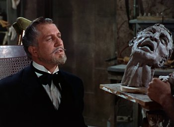 Movie still from “House of Wax” (1953), directed by André De Toth – An older man in a suit and bow tie looking at a statue; Close Up shot, Low angle