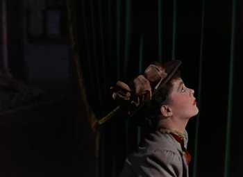 Movie still from “House of Wax” (1953), directed by André De Toth – A young boy wearing a brown hat looking up; Medium shot, Low angle
