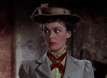 Movie still from “House of Wax” (1953), directed by André De Toth – A person wearing a suit and a hat; Close Up shot, Low angle