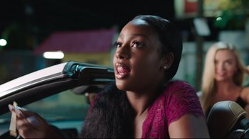 Movie still from “How High 2” (2019), directed by Bruce Leddy – A woman in a purple dress sitting in a car; Close Up shot, Over the shoulder angle