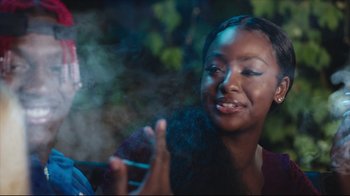 Movie still from “How High 2” (2019), directed by Bruce Leddy – A young woman smoking a cigarette in the dark; Close Up shot, Over the shoulder angle