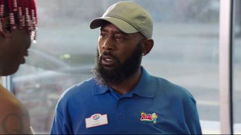 Movie still from “How High 2” (2019), directed by Bruce Leddy – A man with a beard wearing a blue shirt and a hat; Close Up shot, Over the shoulder angle