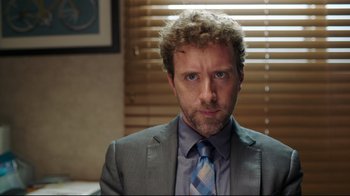 Movie still from “How High 2” (2019), directed by Bruce Leddy – A person wearing a suit and tie; Close Up shot, Over the shoulder angle