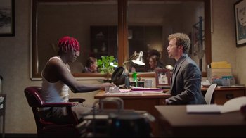 Movie still from “How High 2” (2019), directed by Bruce Leddy – Two people sitting at a table in front of each other; Medium shot, Over the shoulder angle
