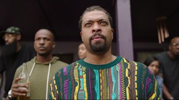 Movie still from “How High 2” (2019), directed by Bruce Leddy – A man with a beard wearing a colorful sweater; Close Up shot, Low angle