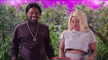 Movie still from “How High 2” (2019), directed by Bruce Leddy – A man standing next to a woman in front of marijuana plants; Medium shot, Over the shoulder angle