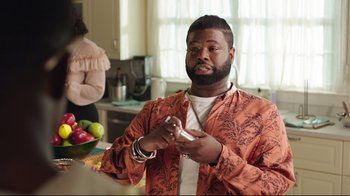 Movie still from “How High 2” (2019), directed by Bruce Leddy – A man holding a nintendo wii game controller in his hand; Medium shot, Over the shoulder angle