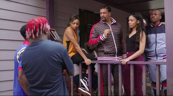 Movie still from “How High 2” (2019), directed by Bruce Leddy – A group of people standing on top of a wooden railing; Medium shot, Over the shoulder angle