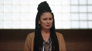 Movie still from “How High 2” (2019), directed by Bruce Leddy – A woman with braids is crying in front of a brick wall; Close Up shot, Over the shoulder angle