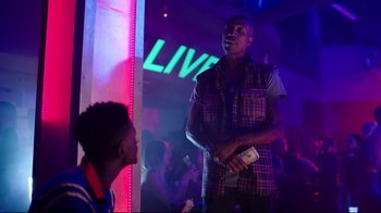 Movie still from “How High 2” (2019), directed by Bruce Leddy – A man standing in front of a crowd holding a microphone; Medium shot, Over the shoulder angle